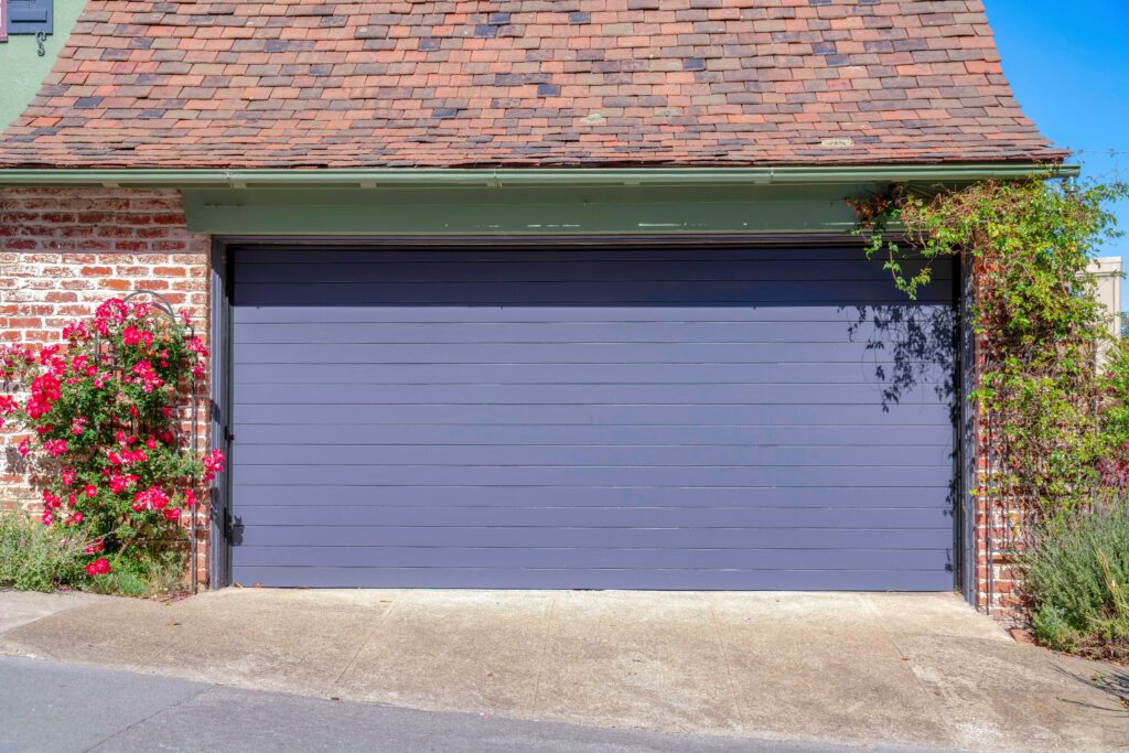 Discover the types of garage doors, like this residential roll up garage door in purple so you can choose what's right for you and your home. Get informed with Affordable Garage Door Fix!